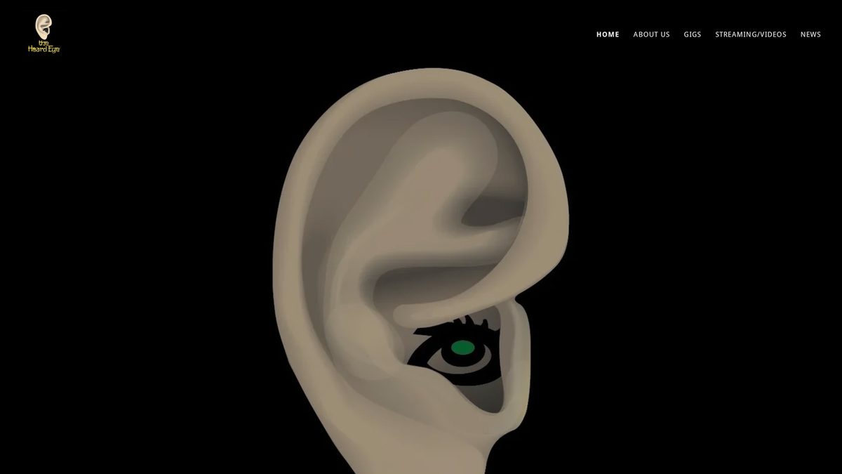 Home page of theheardeye.com, a large ear illustration with an eye inside on a black background